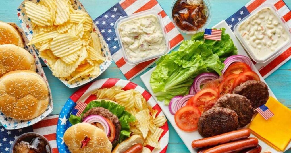 Alimentos inflamatórios representados em uma mesa, incluindo açúcar refinado, alimentos ultraprocessados, frituras e bebidas alcoólicas